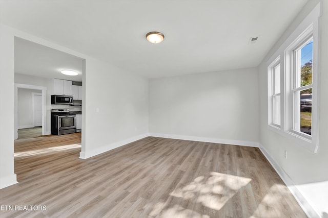 spare room with light hardwood / wood-style floors