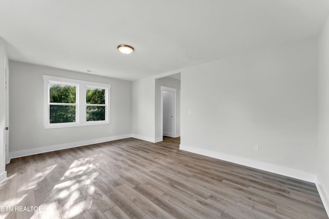 empty room with light hardwood / wood-style flooring