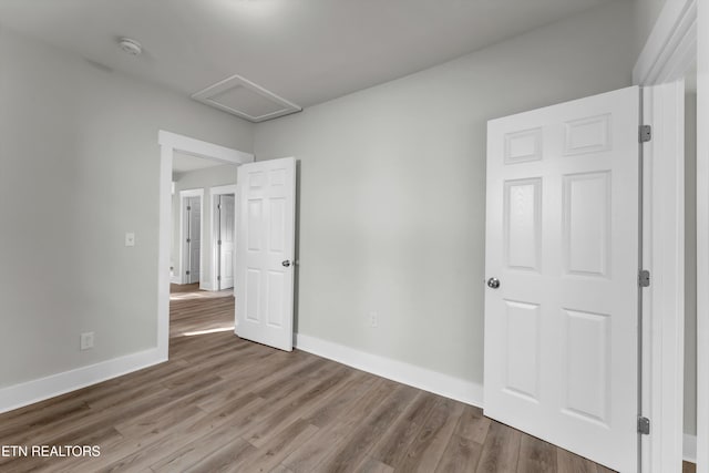 unfurnished bedroom with hardwood / wood-style flooring