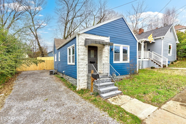 bungalow-style house featuring central AC unit