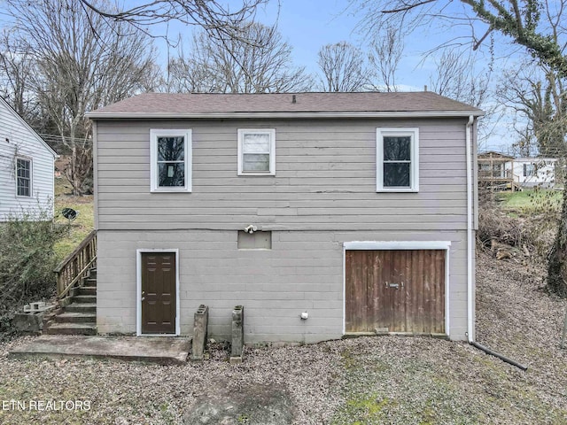 back of house featuring a garage