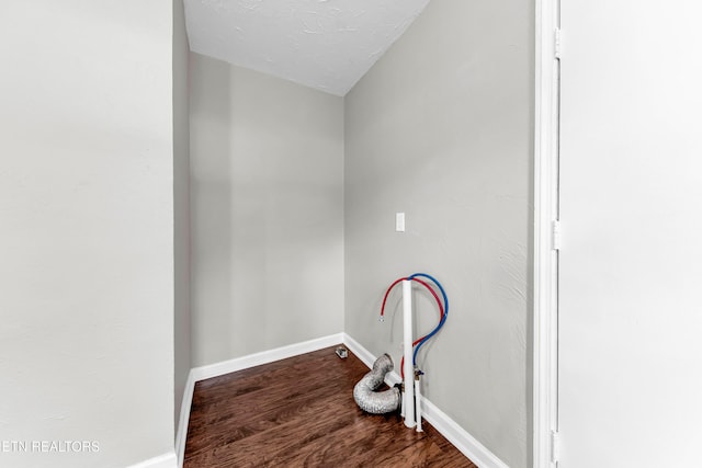 washroom featuring hardwood / wood-style floors and a textured ceiling