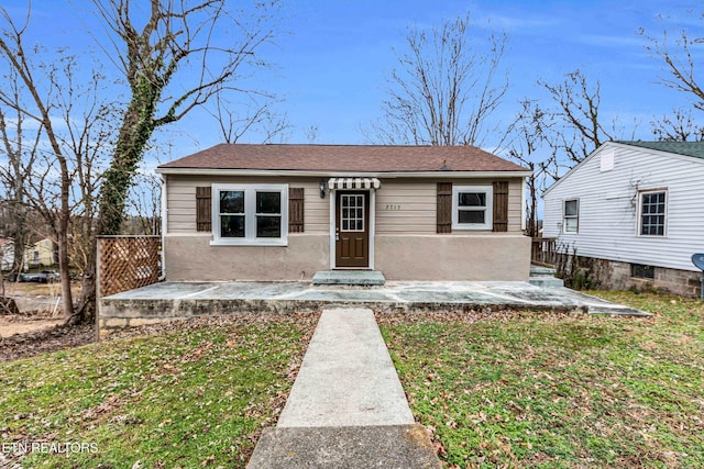 view of front of house with a patio area and a front lawn