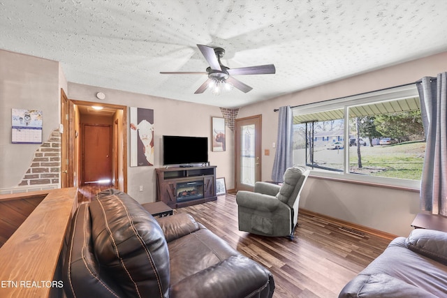 living room featuring a fireplace, hardwood / wood-style flooring, and ceiling fan