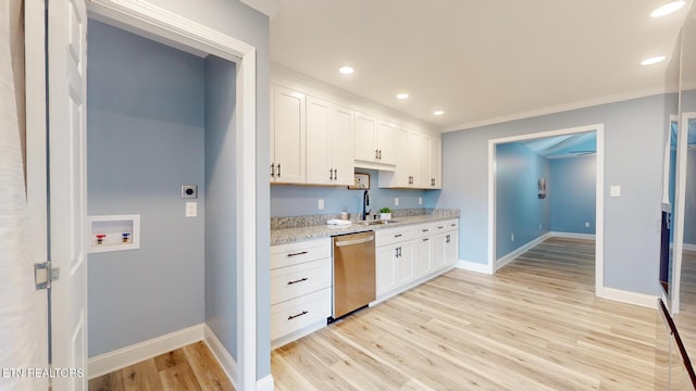 kitchen featuring white cabinets, a sink, light wood-style flooring, and stainless steel dishwasher