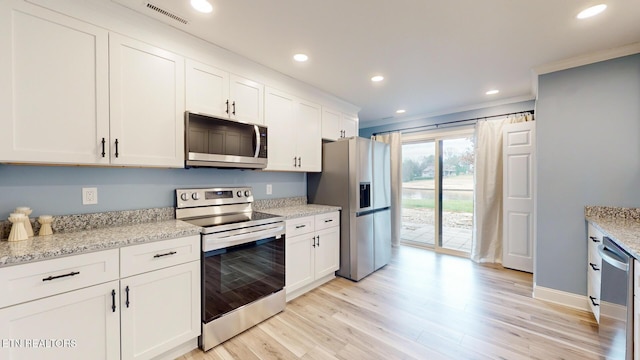 kitchen with visible vents, appliances with stainless steel finishes, light wood-type flooring, white cabinetry, and recessed lighting