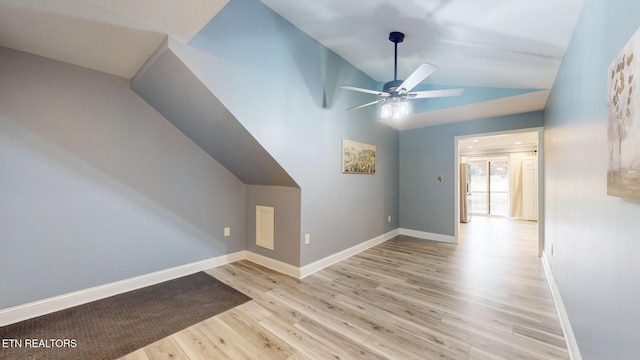 bonus room with lofted ceiling, ceiling fan, light wood finished floors, and baseboards