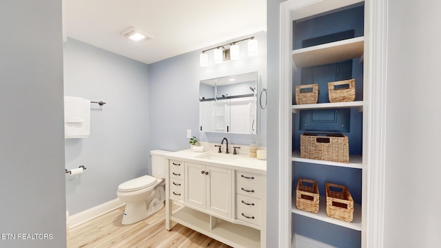 full bath featuring baseboards, vanity, toilet, and wood finished floors