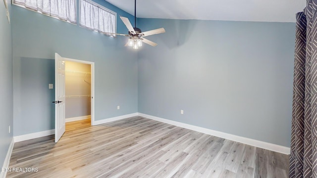 unfurnished room with ceiling fan, wood finished floors, and baseboards