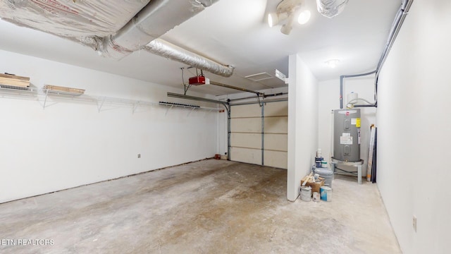 garage with water heater and a garage door opener