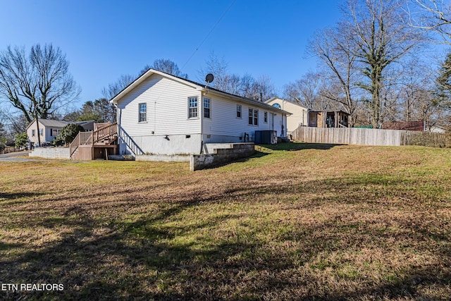 view of side of property with a yard and cooling unit