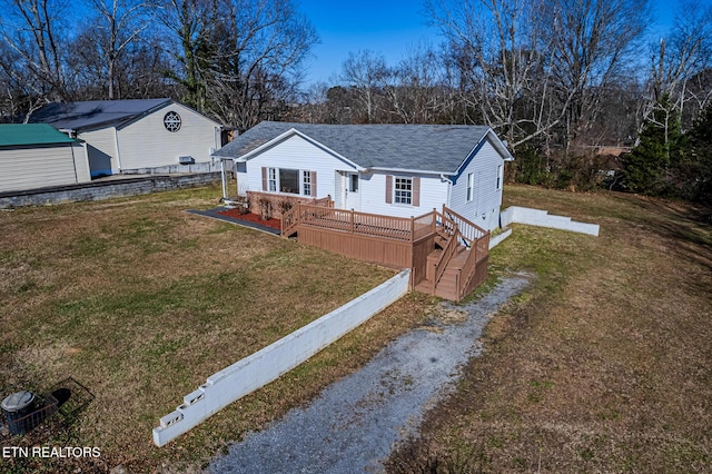 view of front of house featuring a wooden deck and a front yard