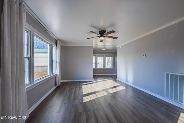 unfurnished room featuring ornamental molding, ceiling fan, and dark wood-type flooring