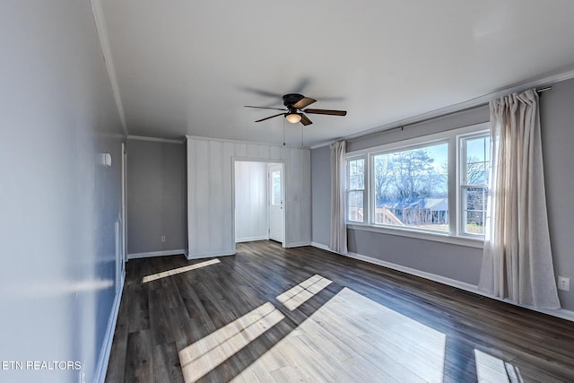 unfurnished room with dark hardwood / wood-style flooring, ceiling fan, and crown molding