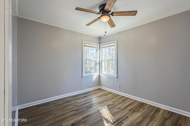 spare room with ceiling fan, crown molding, and dark wood-type flooring