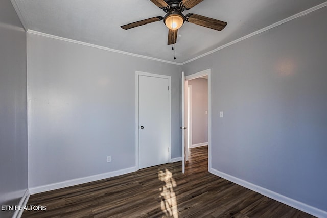 spare room featuring dark hardwood / wood-style floors, ceiling fan, and ornamental molding