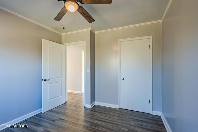 unfurnished bedroom featuring dark hardwood / wood-style flooring, ceiling fan, and crown molding