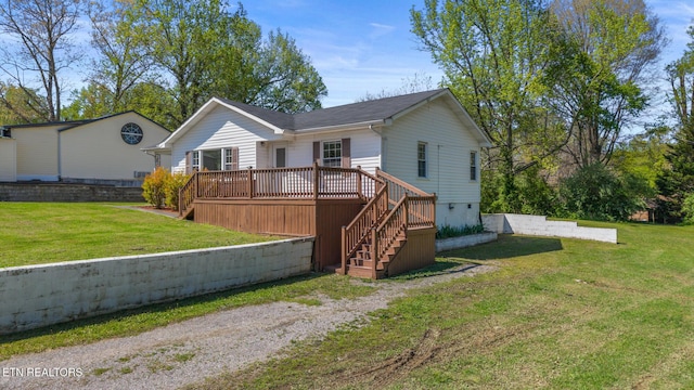 view of front of house featuring a front yard, stairway, and a deck
