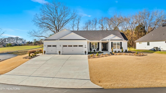 view of front of property with a garage and a front lawn