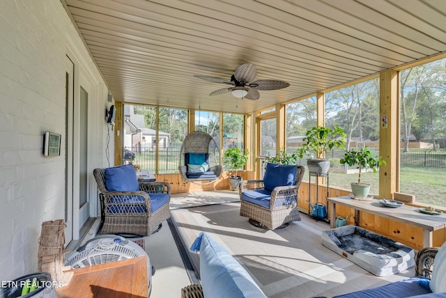 sunroom featuring ceiling fan