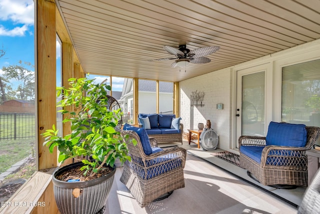 sunroom featuring ceiling fan