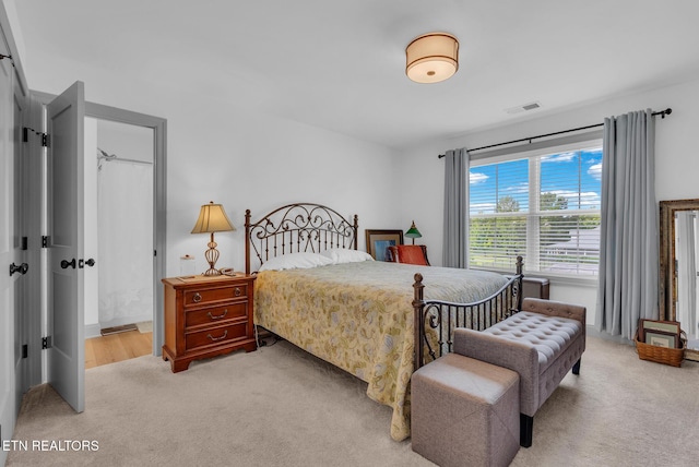 bedroom featuring light colored carpet