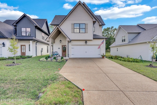 view of front of property with a front yard and a garage