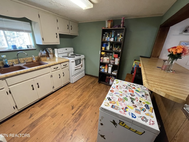 kitchen with a textured ceiling, sink, electric stove, light hardwood / wood-style flooring, and white cabinetry