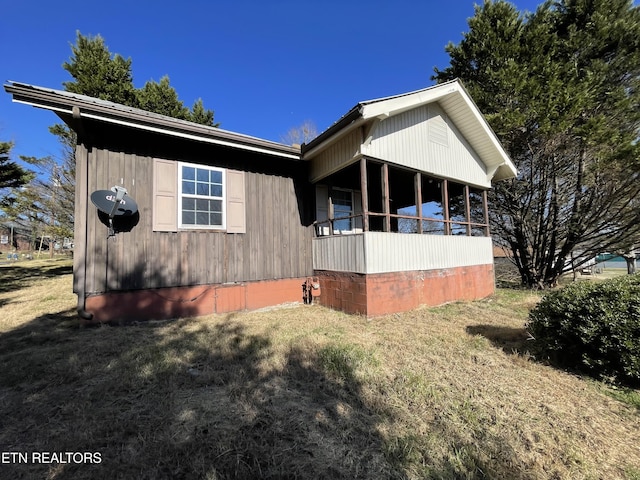 view of side of home with a lawn