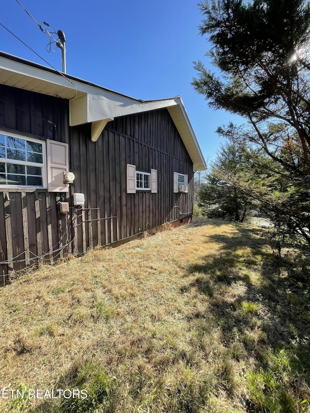 view of side of home with a lawn