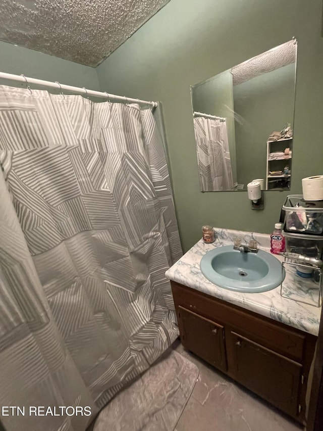 bathroom with vanity and a textured ceiling