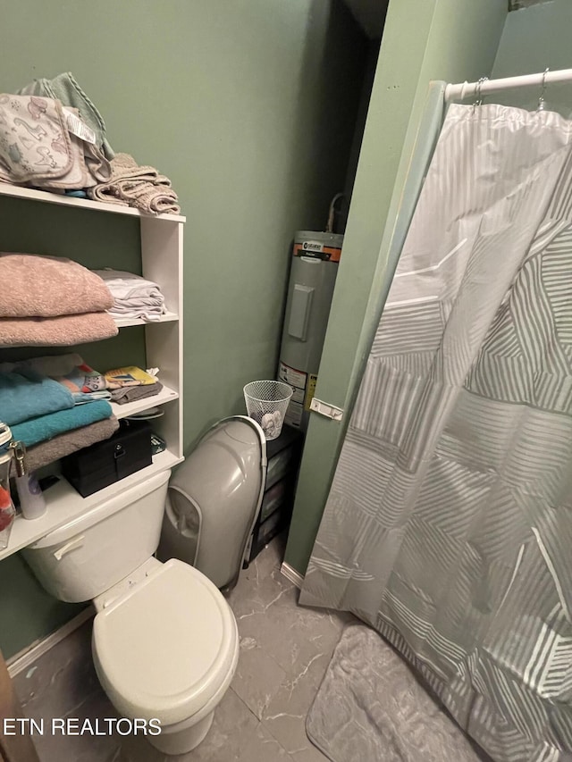 bathroom featuring electric water heater and toilet