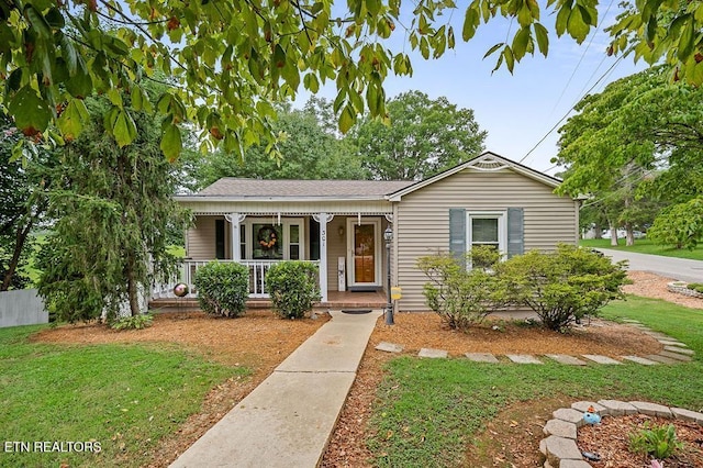 view of front of home featuring covered porch and a front yard