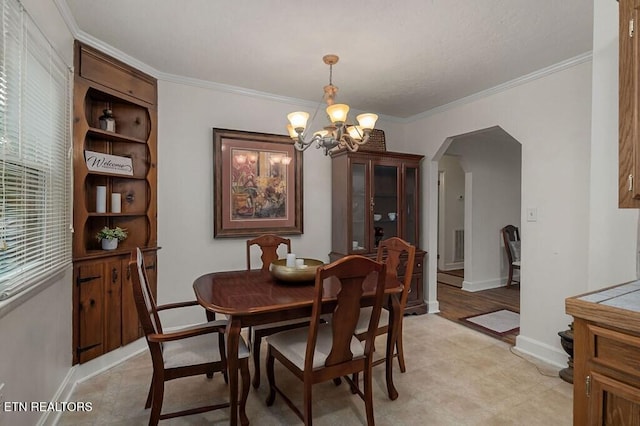 dining space with an inviting chandelier and crown molding