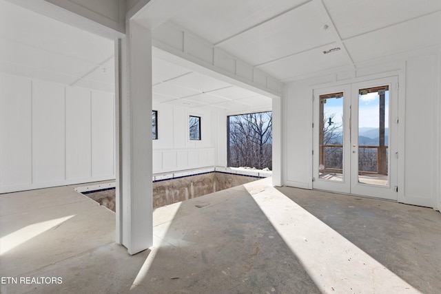 interior space featuring french doors and concrete floors