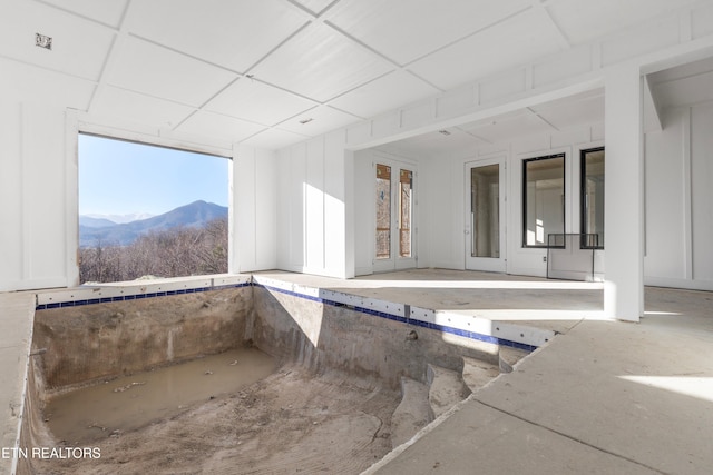 interior space with a mountain view and a drop ceiling