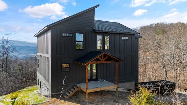 rear view of house featuring a mountain view