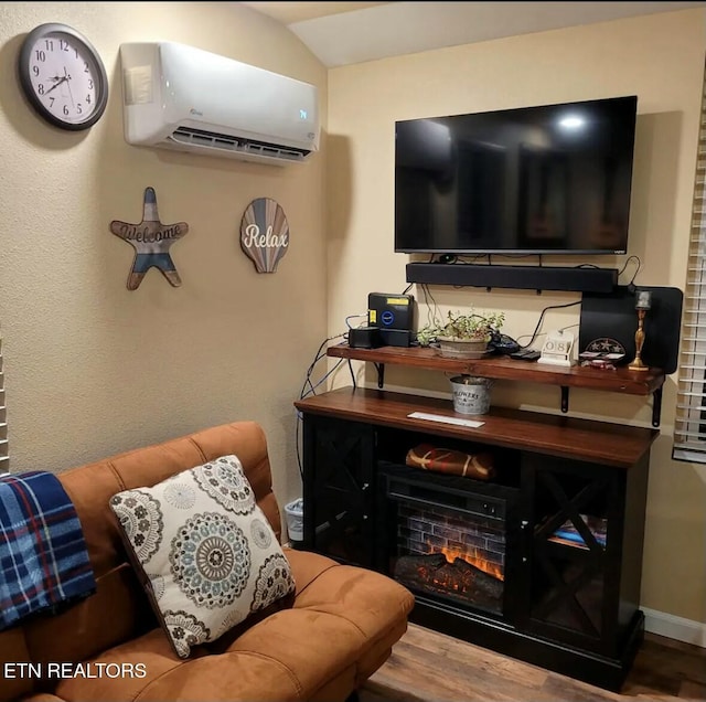 living room featuring wood-type flooring and a wall mounted AC