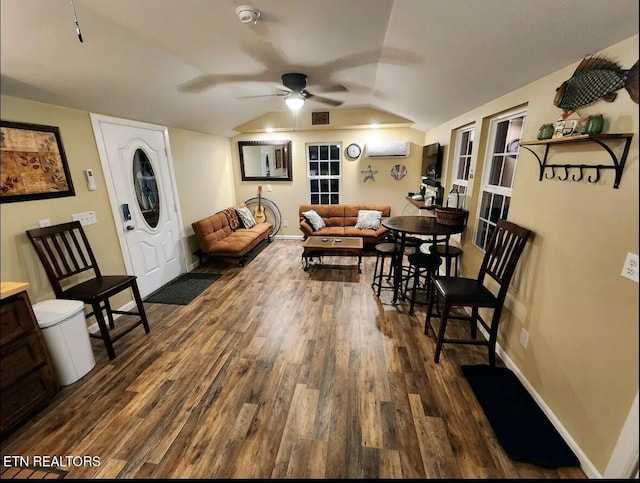 living room with vaulted ceiling, ceiling fan, dark hardwood / wood-style floors, and a wall mounted air conditioner