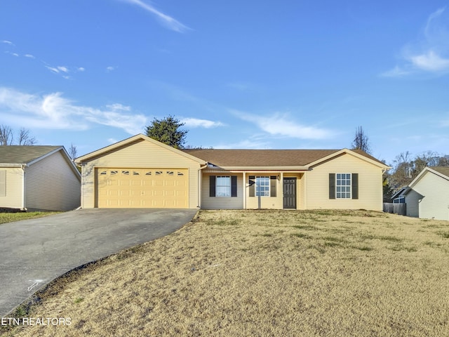 ranch-style house featuring a garage and a front lawn