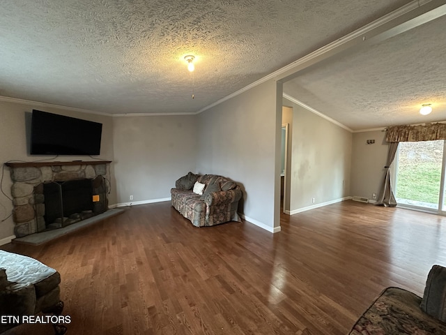 living room with crown molding, a fireplace, a textured ceiling, and wood-type flooring