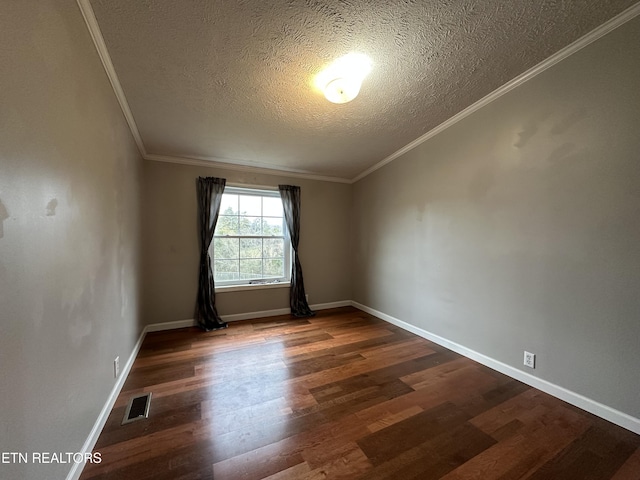 empty room with ornamental molding, a textured ceiling, and dark hardwood / wood-style flooring