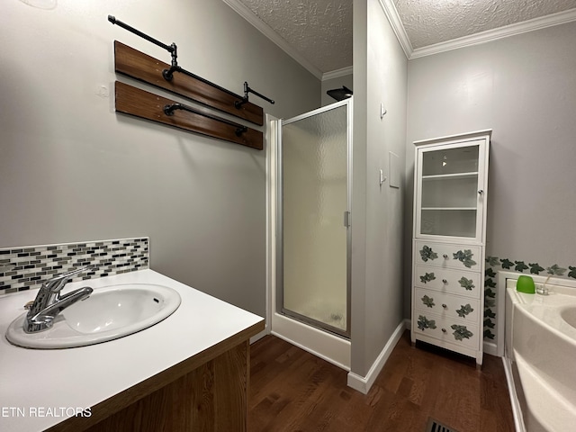 bathroom with backsplash, hardwood / wood-style floors, a textured ceiling, and plus walk in shower