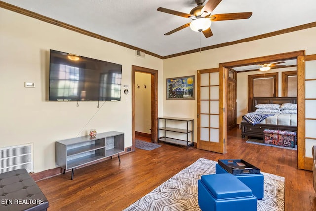 living room with ceiling fan, french doors, dark wood-type flooring, and ornamental molding