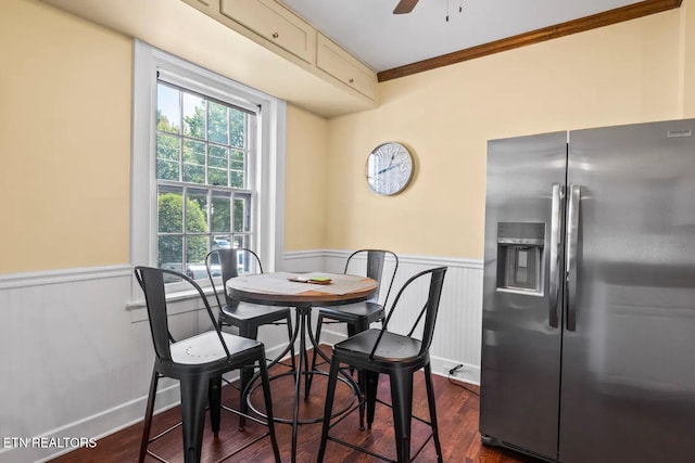 dining space with ceiling fan, ornamental molding, and dark wood-type flooring