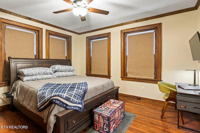 bedroom featuring ceiling fan, crown molding, and dark wood-type flooring