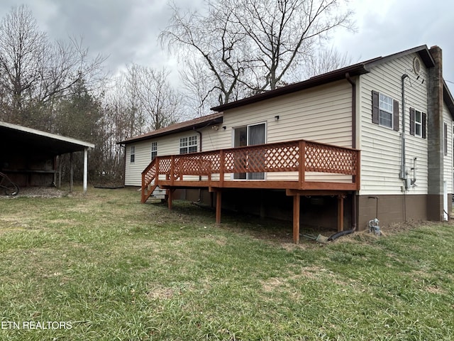 rear view of property featuring a yard, a deck, and a carport