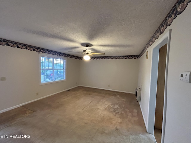 unfurnished room with carpet flooring, a textured ceiling, and ceiling fan