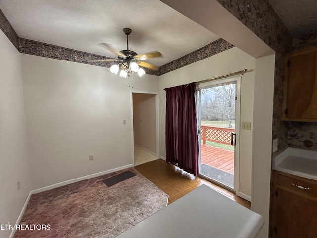 dining room featuring ceiling fan and sink