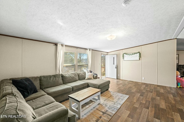 living room featuring crown molding, a textured ceiling, and hardwood / wood-style flooring